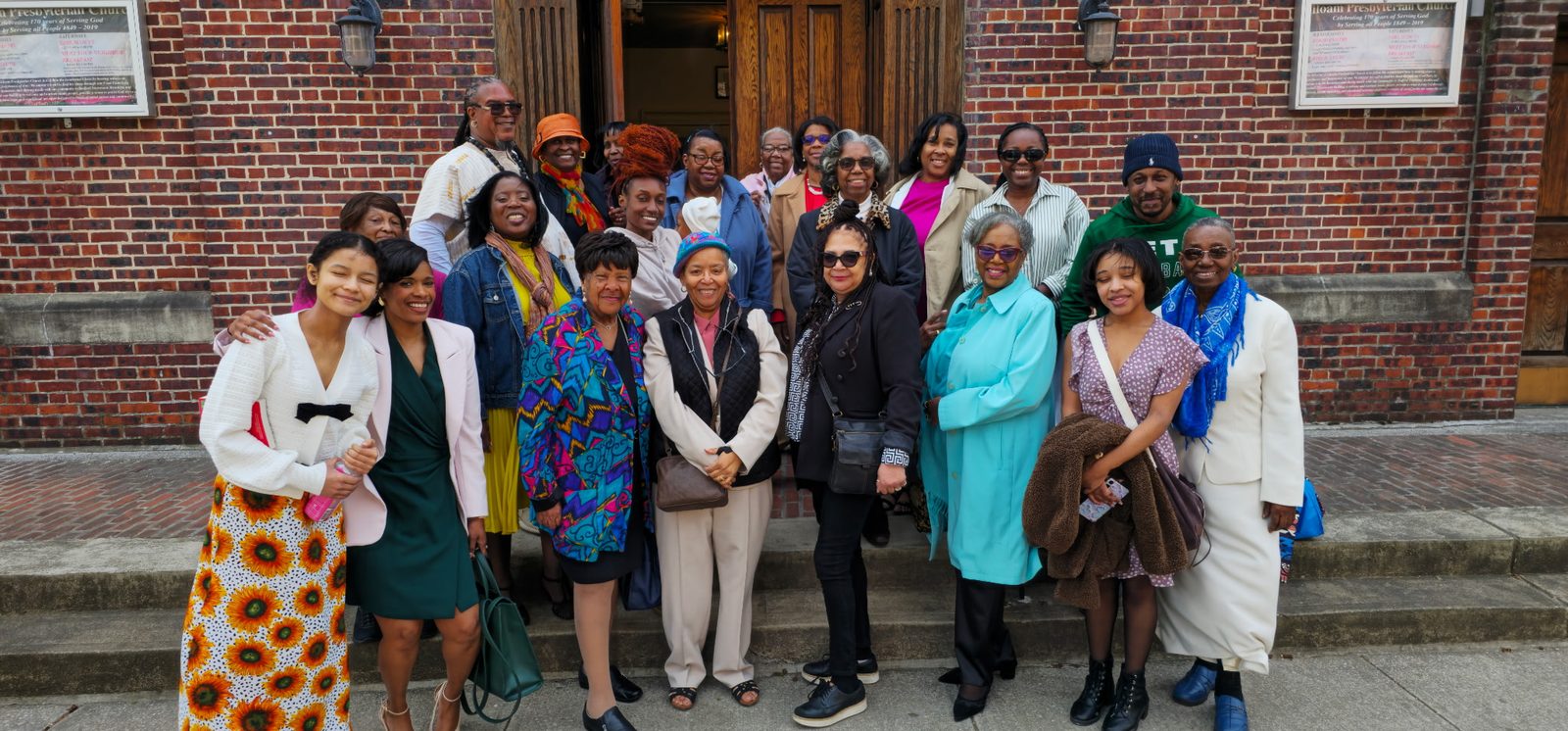 A large group of members and friends gathered on the church's front steps