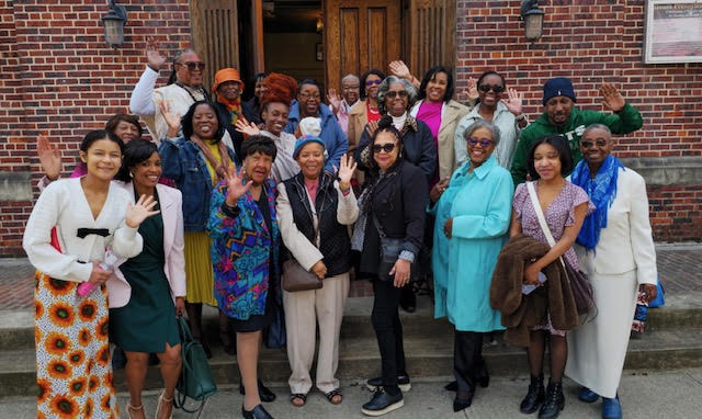 Members of Siloam Presbyterian Church waving together on the front steps