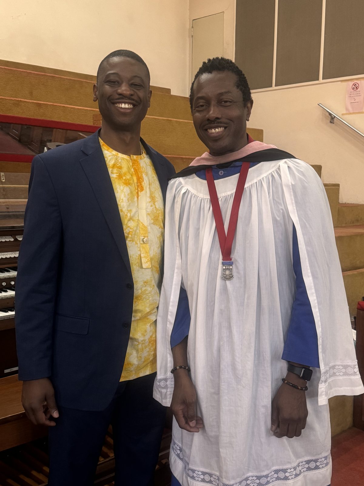 Edward Washington II, tenor, and George Davey, organist, smiling together in the sanctuary